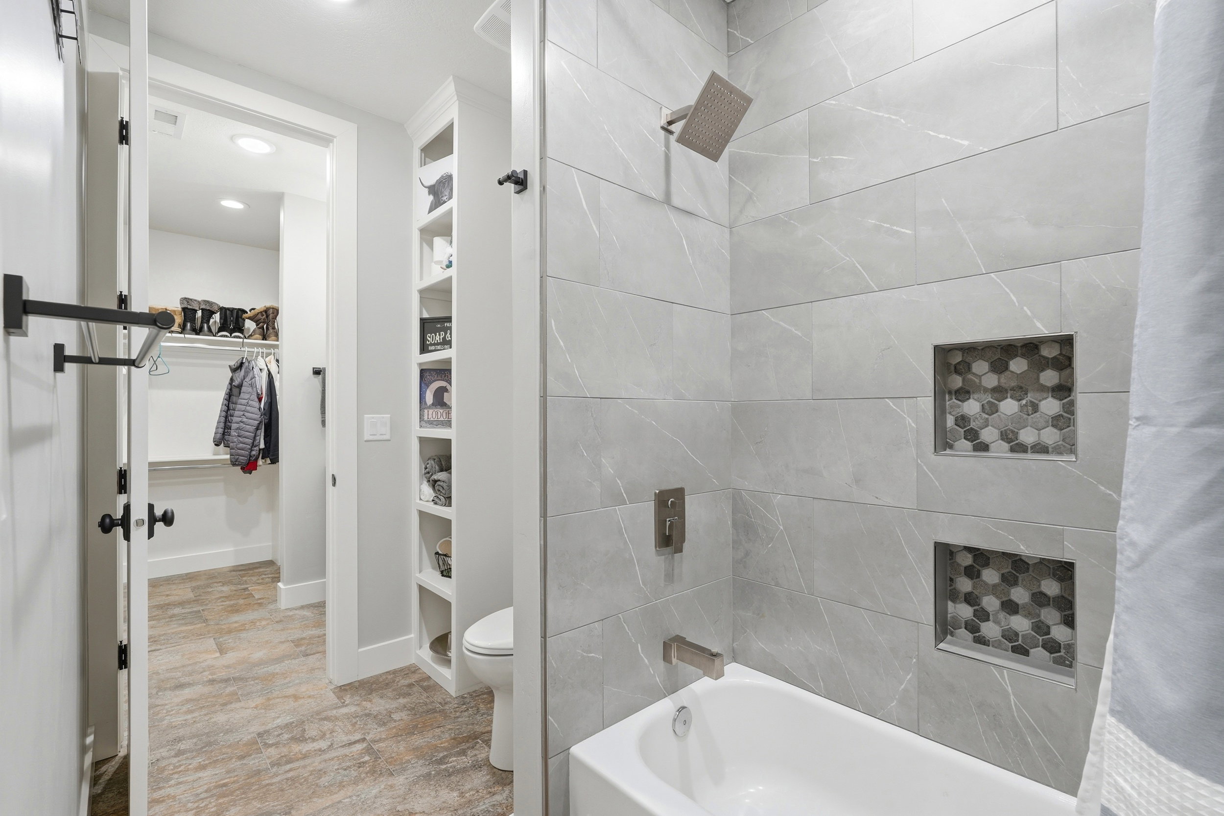 Bathroom featuring a spacious closet, built in features, shower / tub combo with curtain, and recessed lighting