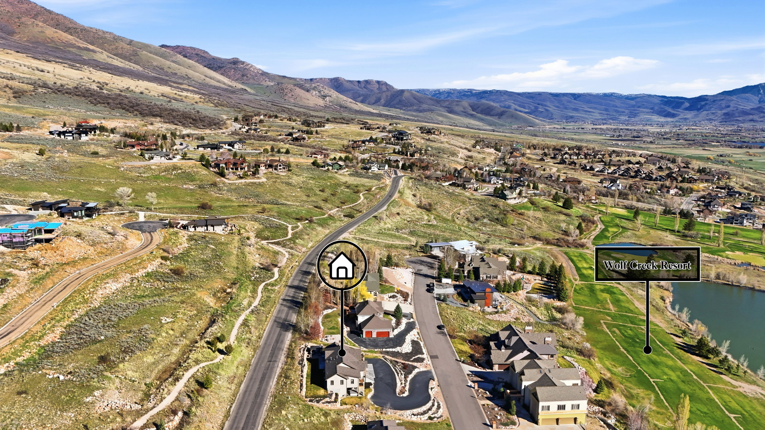 Aerial view of property and surrounding area with nearby suburban area and a water and mountain view