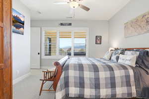 Bedroom featuring light carpet and a ceiling fan