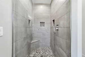 Full bath with a tile shower