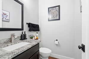 Bathroom with vanity and dark wood-type flooring