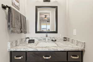 Bathroom featuring vanity and ceiling fan