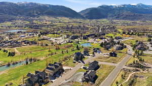 Aerial view of residential area with a water and mountain view and a local golf course