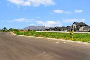 View of asphalt street with curbs and a mountain view