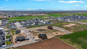 Aerial view of property's location with nearby suburban area and a mountainous background