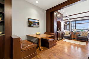 Dining room featuring beam ceiling, light wood-style flooring, and recessed lighting