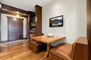Dining area with light wood-type flooring and built in features