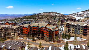 Snowy aerial view with a mountain view and a residential view