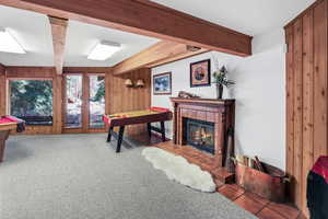 Lower floor walk-out family room and game room with wood-burning fireplace