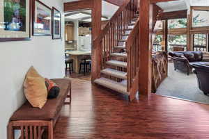 Stairway featuring wood-type flooring
