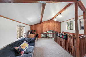 Upper level seating area and work space with desk beyond