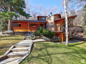 Classic mountain home with 3 floors, large, beautiful yard, 2 masonry stone fireplaces, 5 bedrooms, 4 baths, large, wrap-around deck. Perfect location!