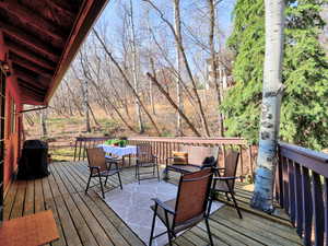 Large deck with an outdoor seating, dining, and room for a hot tub