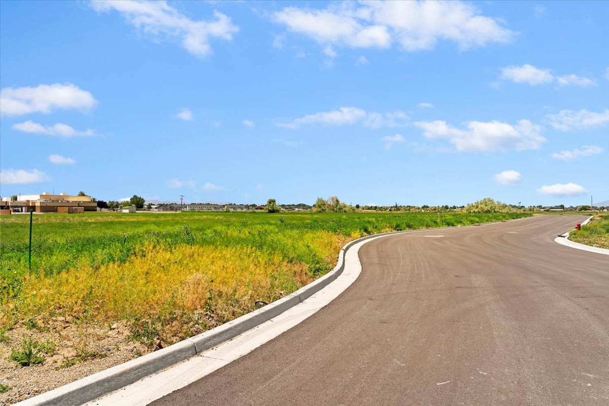 View of asphalt road with curbs