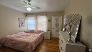 Bedroom with dark wood finished floors and ceiling fan