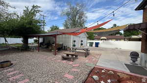 Fenced backyard with a patio and an outdoor structure