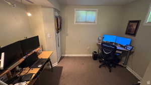 Office featuring dark carpet and baseboards