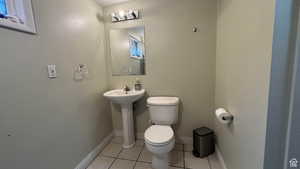 3/4 Bathroom featuring toilet and light tile patterned floors