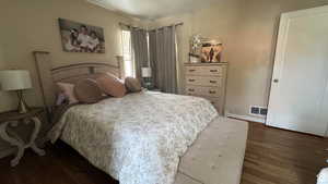 Bedroom with dark wood-style flooring