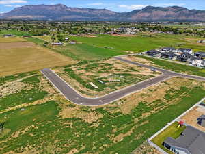Aerial view of property's location with a mountainous background and nearby suburban area