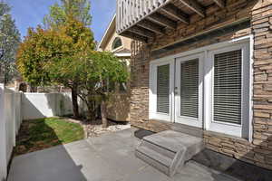 Fenced backyard featuring french doors and a patio area