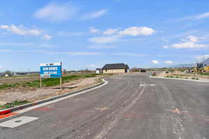 View of asphalt street featuring curbs