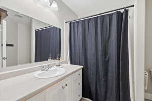 Bathroom with vanity and a shower with shower curtain