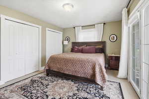 Carpeted bedroom with two closets