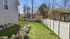 Fenced backyard with a trampoline