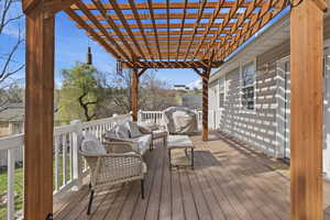 Wooden terrace with an outdoor lounge area and a pergola