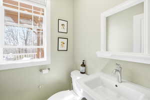 Half bathroom featuring toilet and a sink