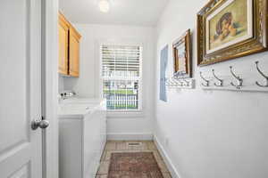 Laundry room with cabinet space and independent washer and dryer