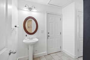 Half bathroom featuring baseboards and light tile patterned flooring