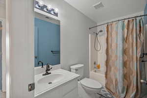 Bathroom featuring vanity and shower / bath combo
