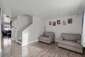 Sitting room featuring wood finished floors and stairway