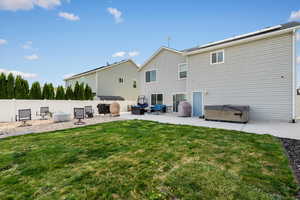 Back of house featuring a patio area, a hot tub, and a fenced backyard