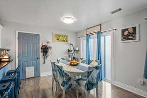 Dining space with wood finished floors and baseboards