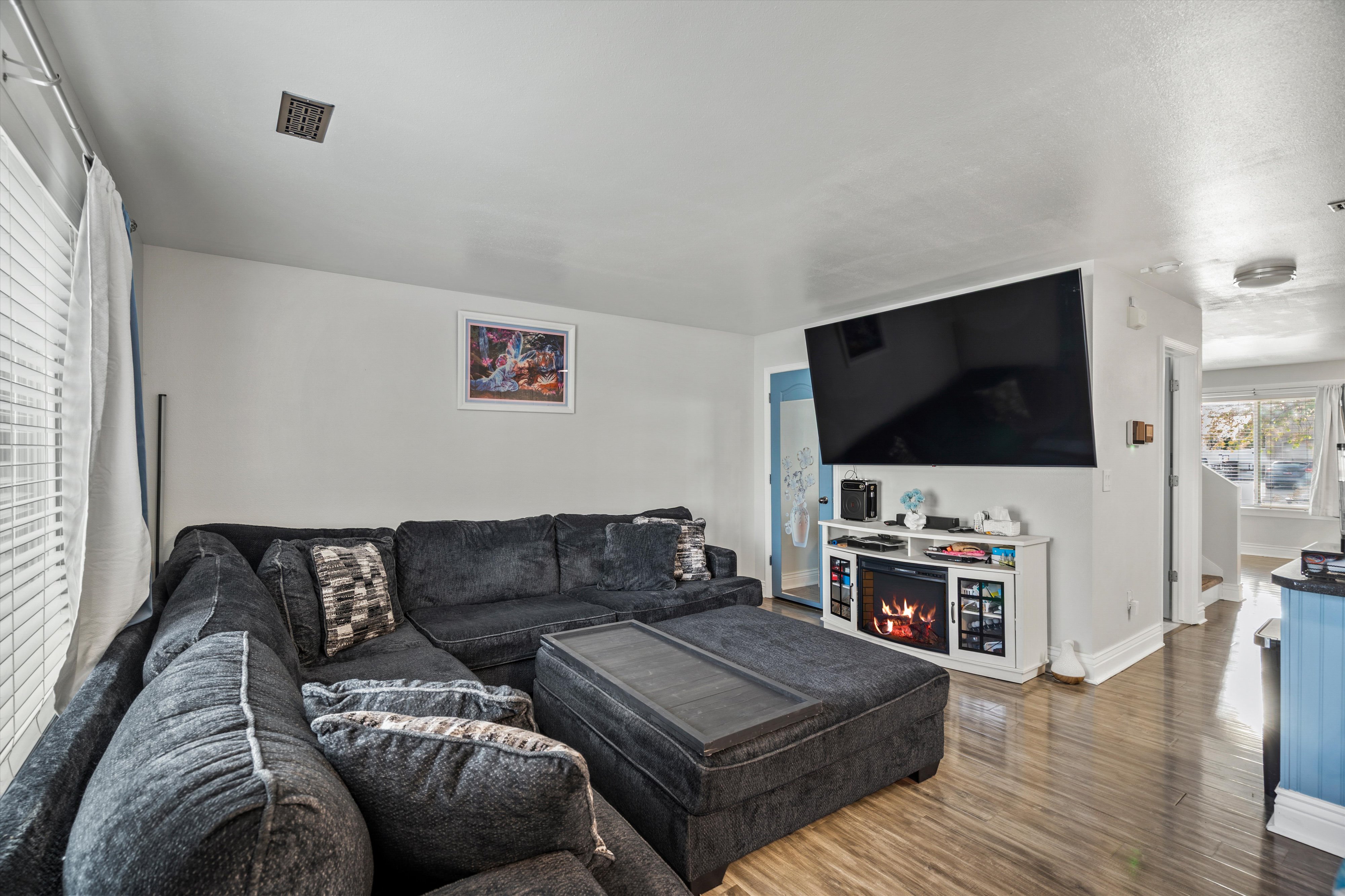 Living room featuring dark wood finished floors and baseboards