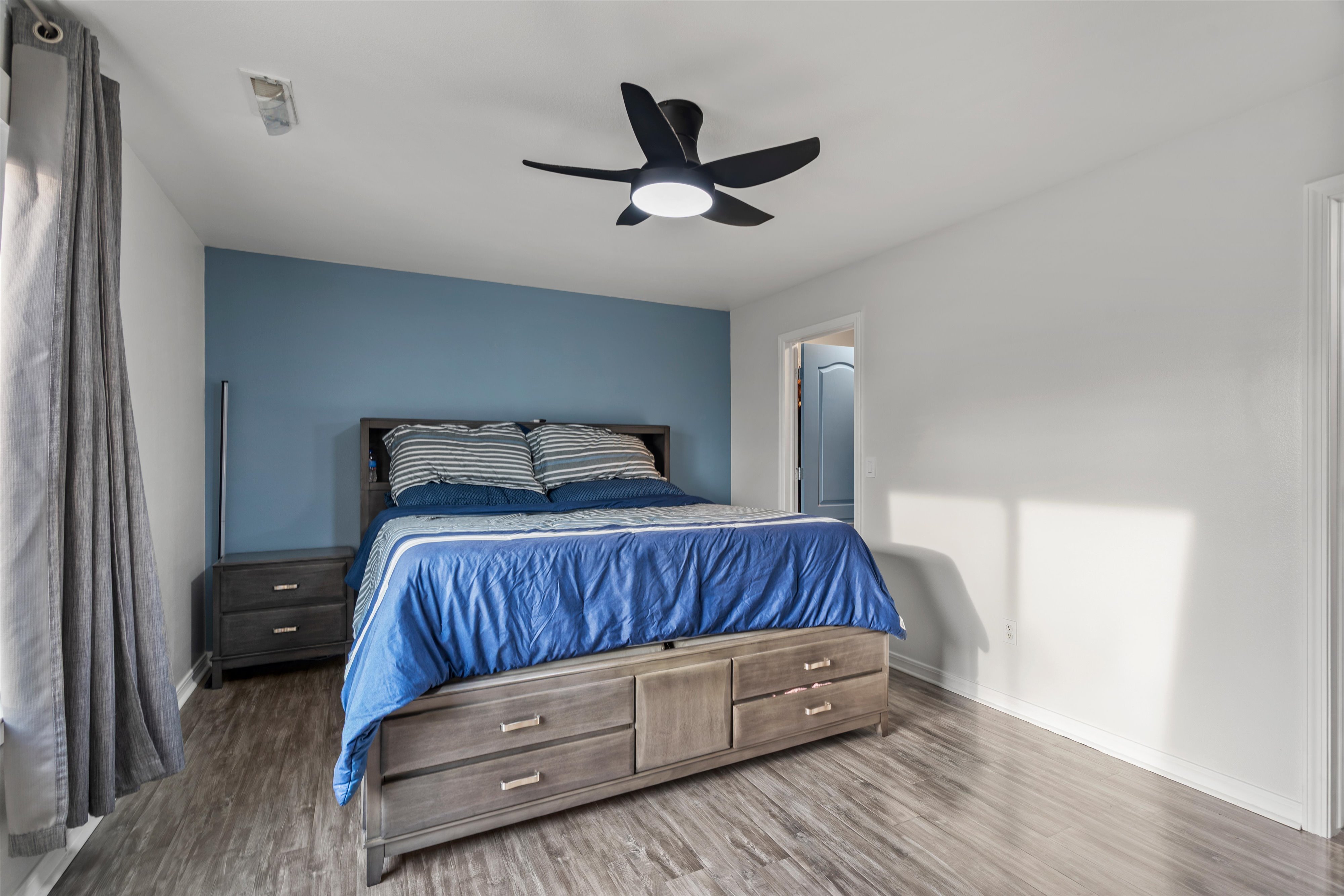 Bedroom featuring wood finished floors and ceiling fan