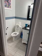 Bathroom with vanity and wainscoting