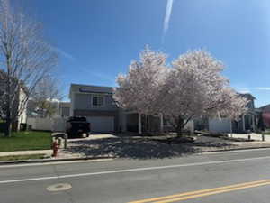 View of front of house with driveway and an attached garage
