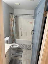 Full bath with vanity and shower / bath combination with curtain