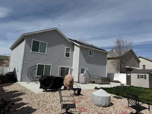 Rear view of house with a patio area, a fenced backyard, and a shed