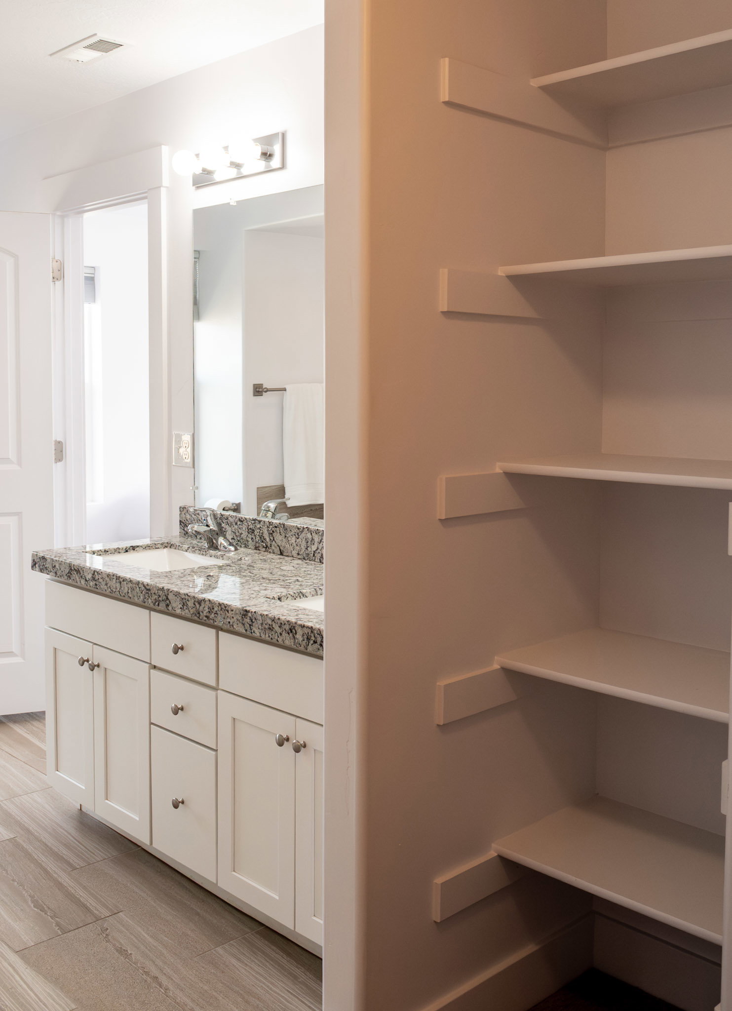 Full bathroom with double vanity and light in Master Bath with linen closet inside walk in closet