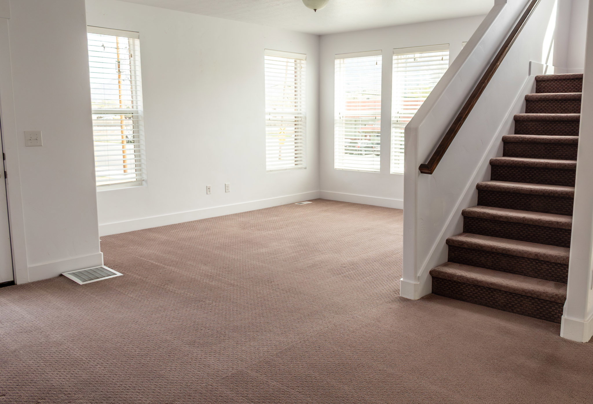 Stairs featuring baseboards and carpet flooring