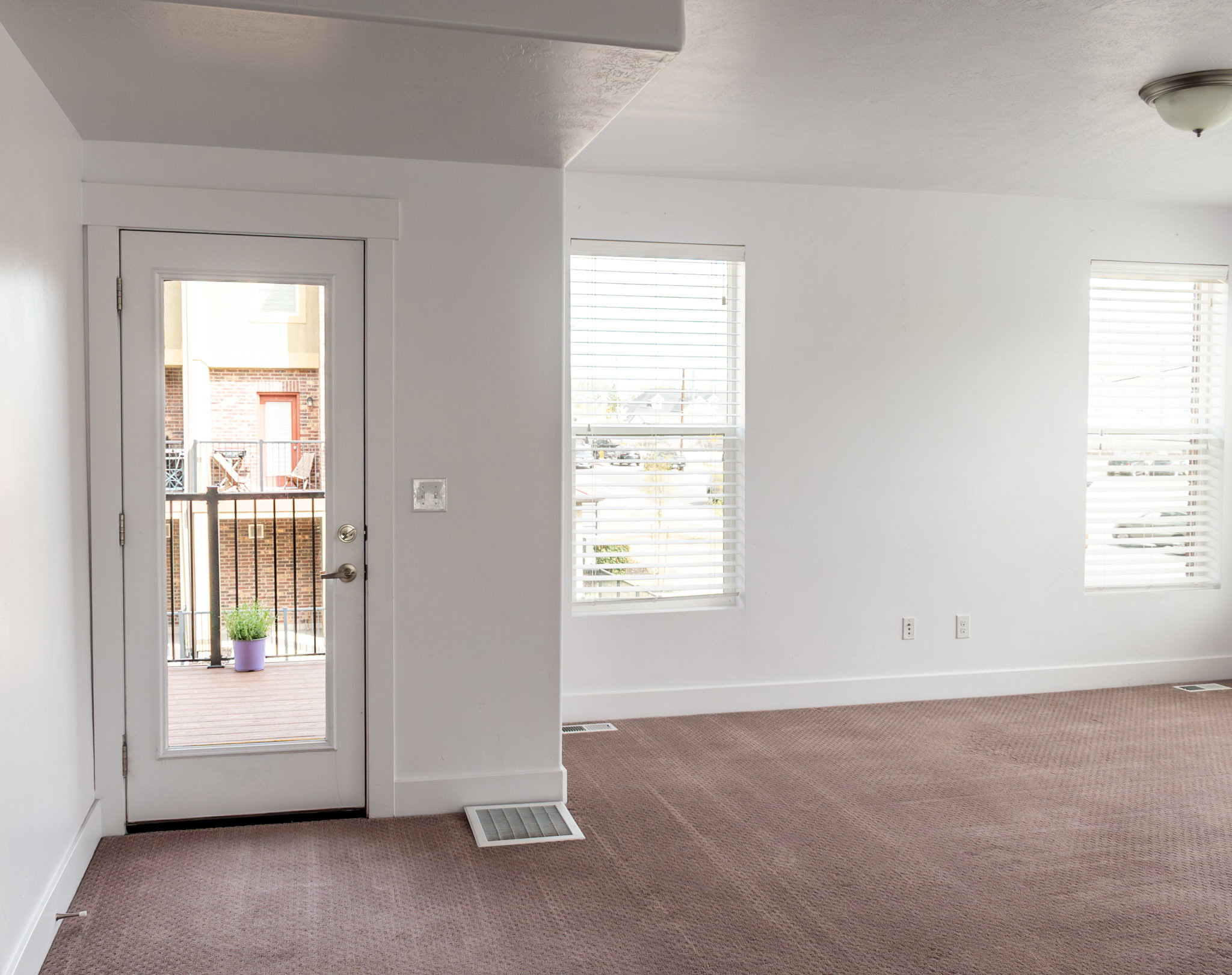 Doorway to outside Deck  featuring baseboards and carpet floors