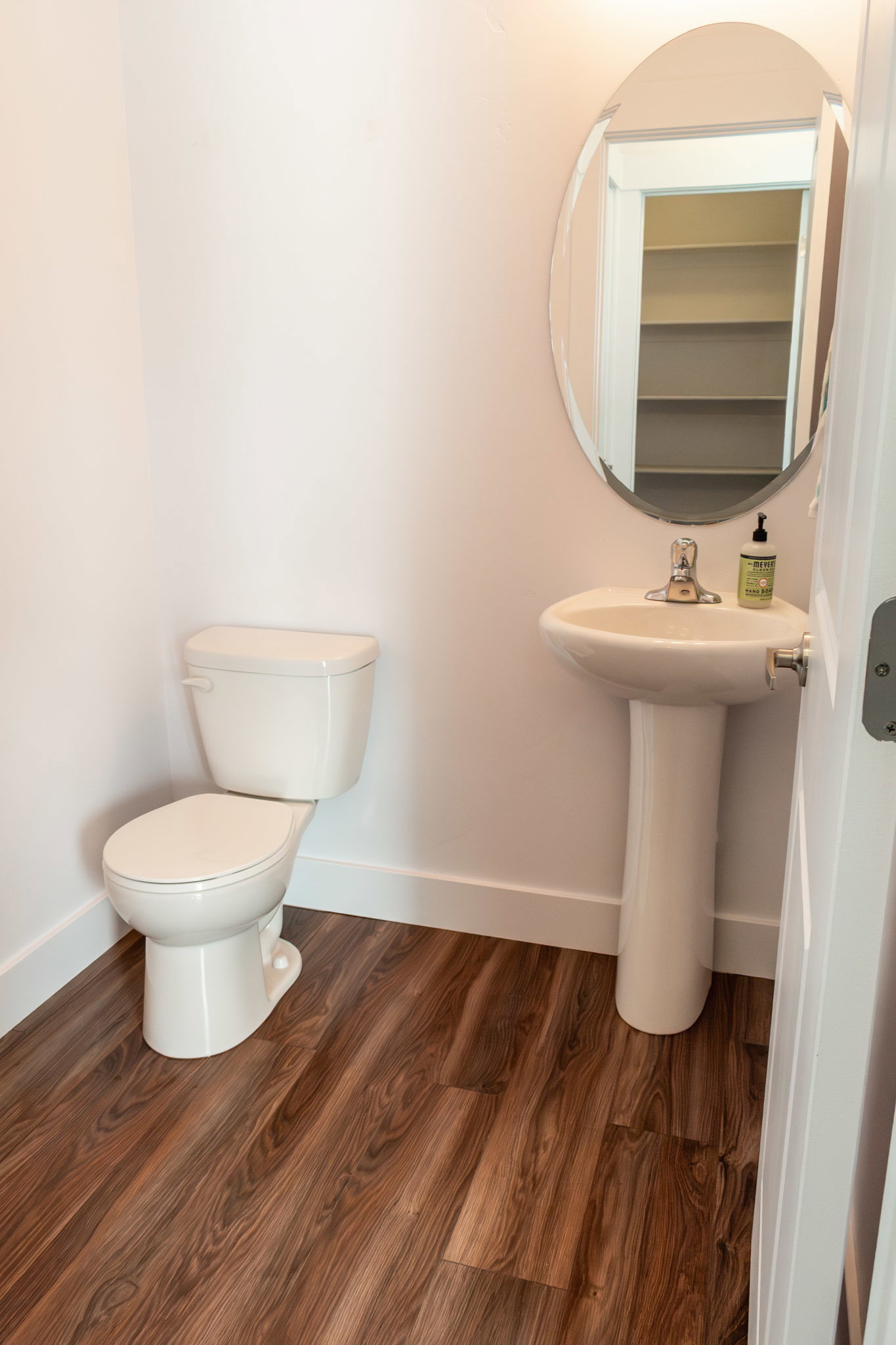 Half bath with toilet and dark wood-style floors