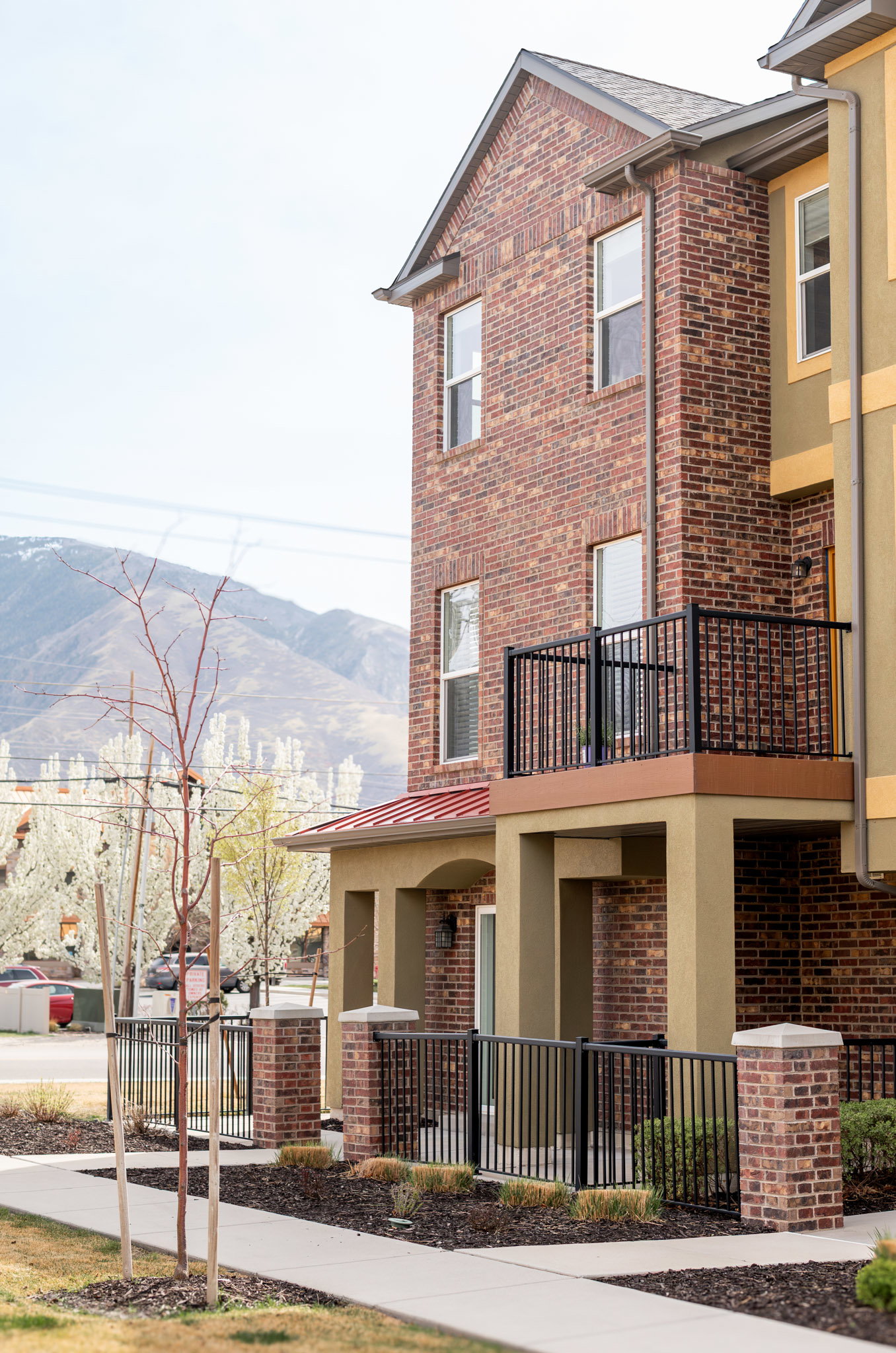 View of front of property featuring brick siding, a standing seam roof, and a mountain view