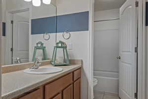 Full bath featuring vanity and light tile patterned floors