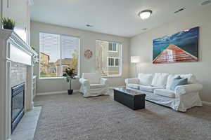 Living room featuring light carpet and a brick fireplace
